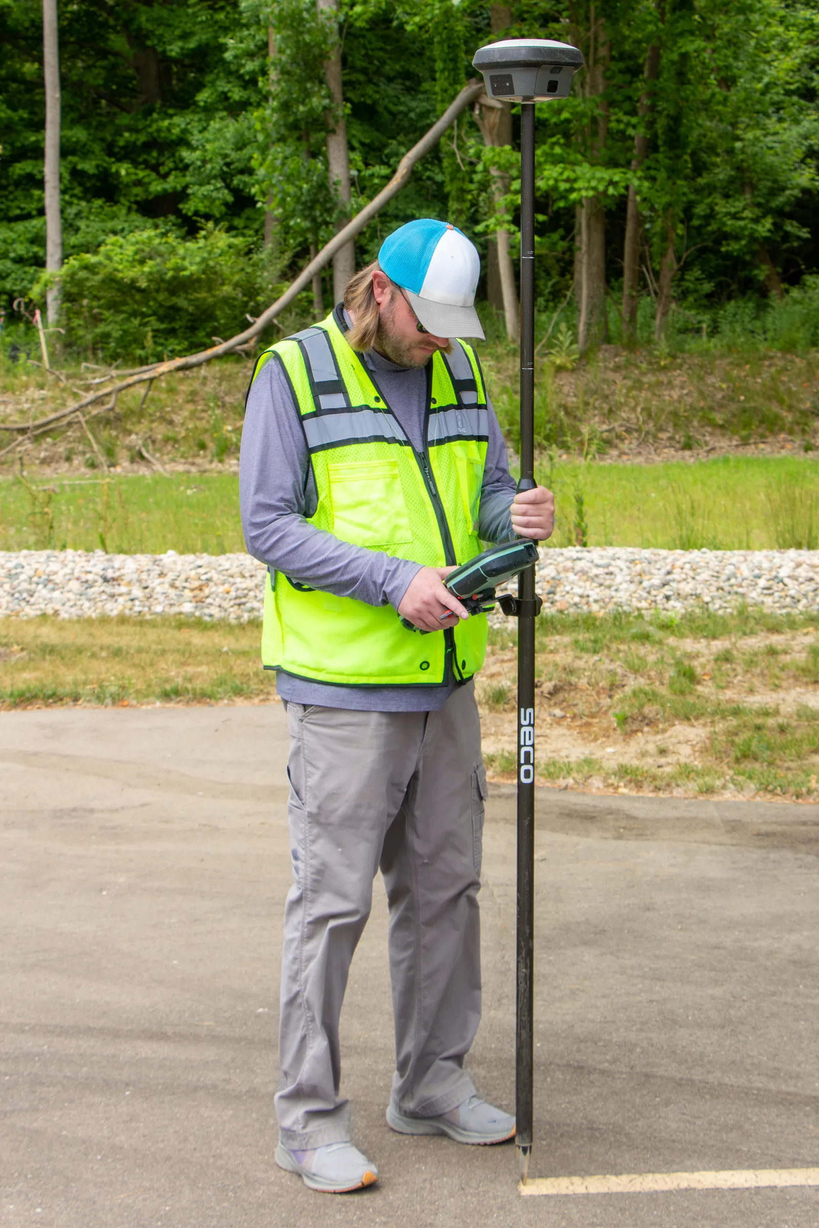 Surveyor using a GNSS receiver with RTK solution in the field — the type of base station setup used in Tier 2 and Tier 3 drone surveys